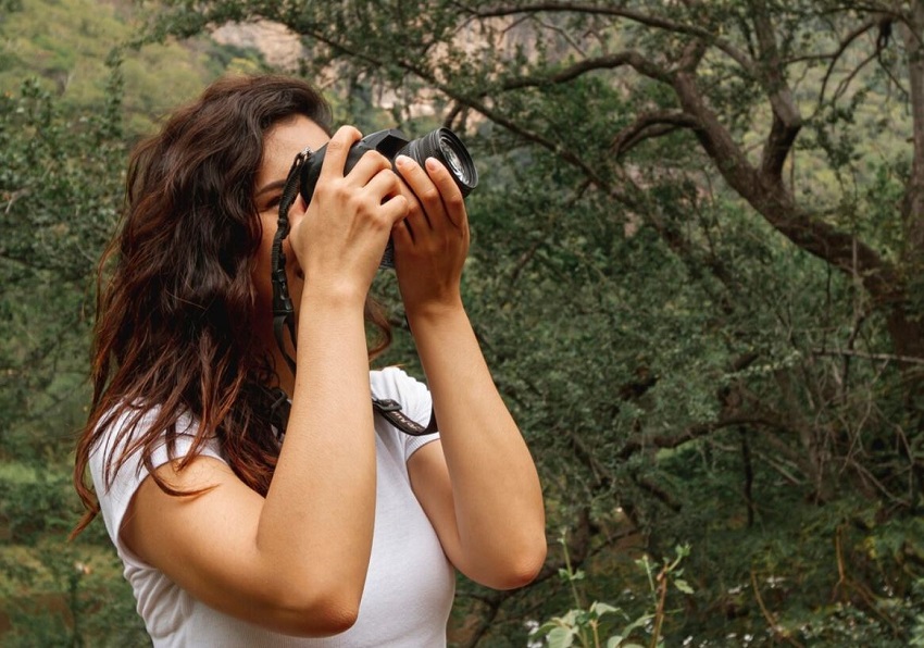 Woman taking a photo in nature